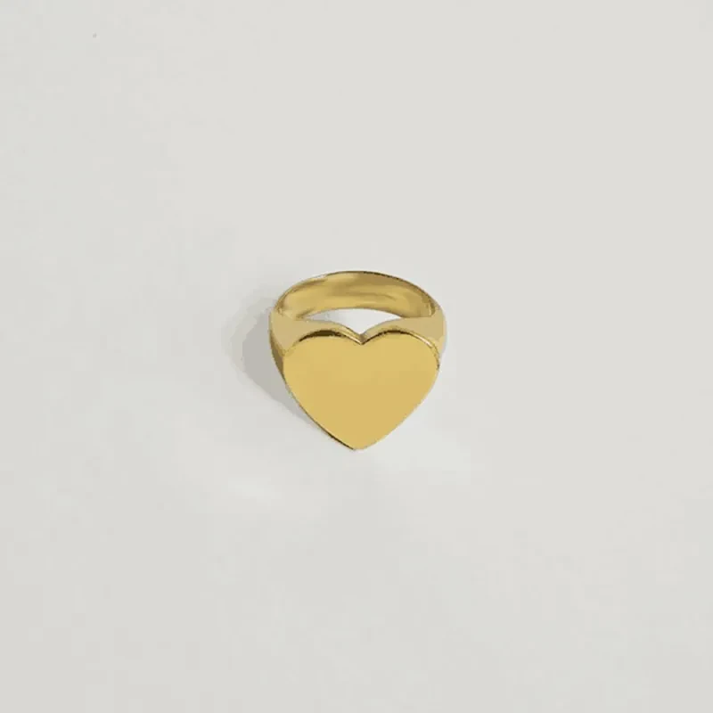 Make a statement with the Creative Hip Hop Fashion Heart-shaped Gold and Silver Color Ring. This bold, eye-catching piece combines modern design with a touch of elegance, perfect for those who love to stand out.