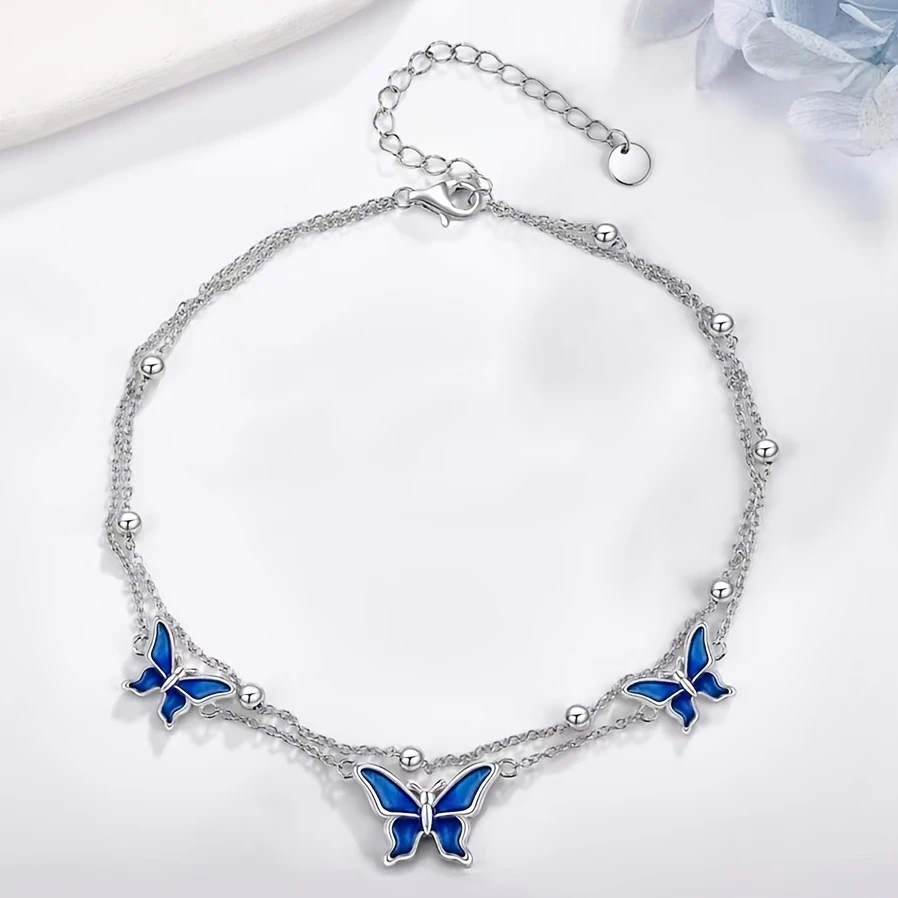 White Golden Butterfly Anklet  Elegant White Golden-Plated Copper Butterfly Anklet with Blue Enamel Accents