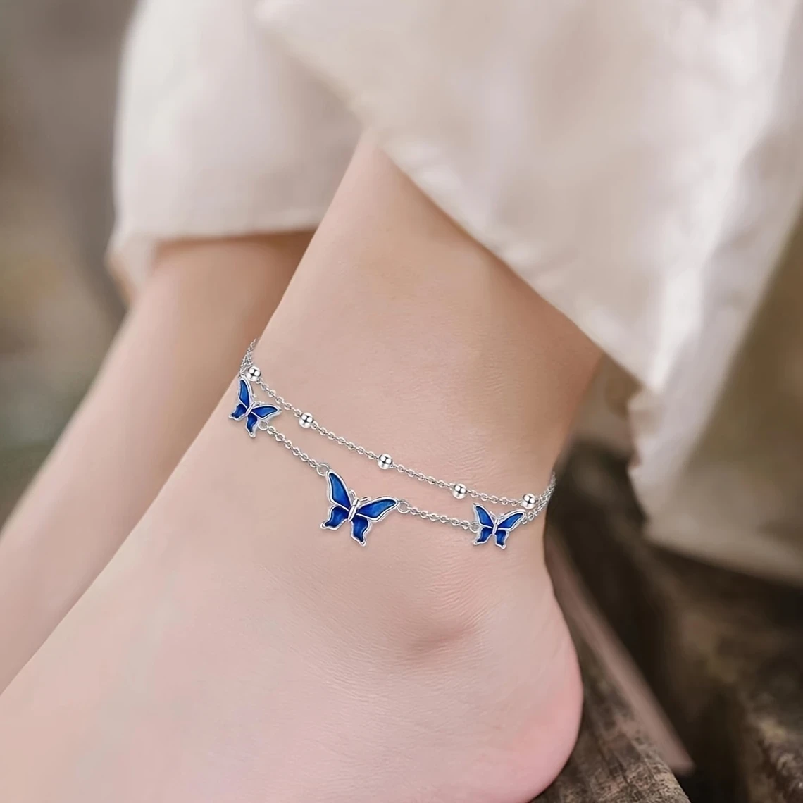 White Golden Butterfly Anklet  Elegant White Golden-Plated Copper Butterfly Anklet with Blue Enamel Accents
